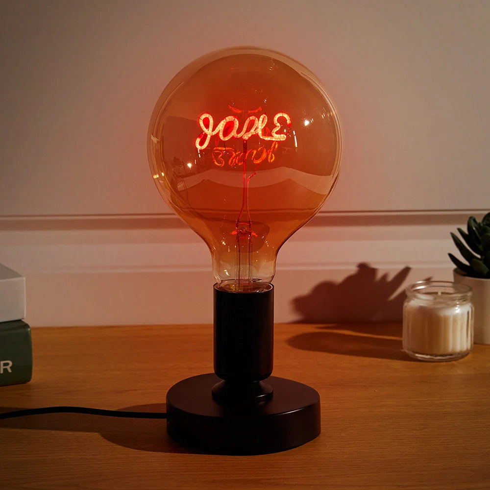 Personalized Edison bulb table lamp with a custom text filament red light